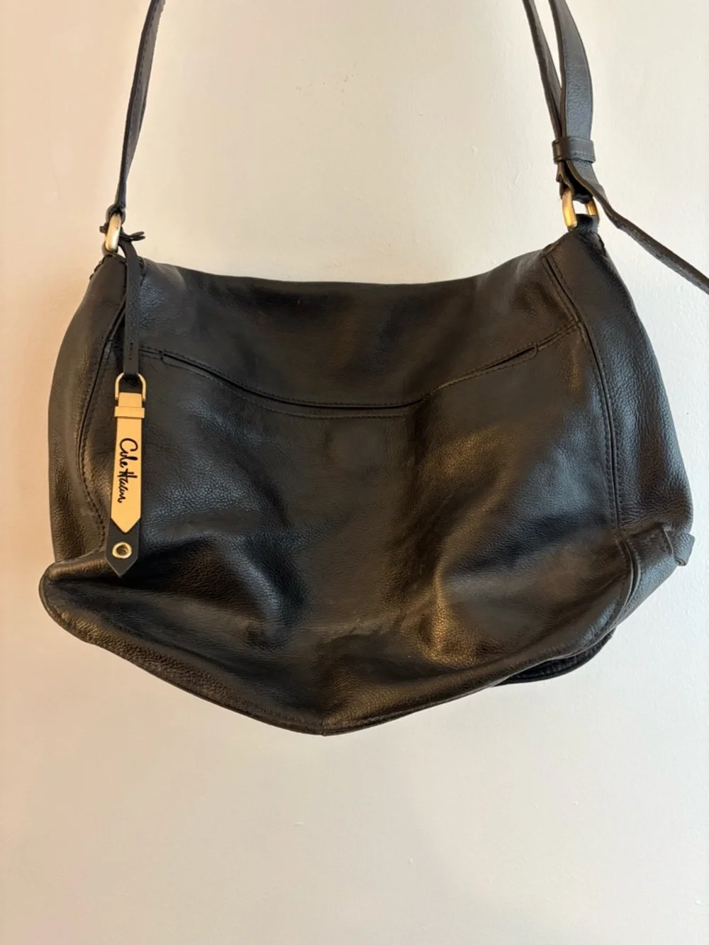Cole Haan black leather messenger bag with gold hardware